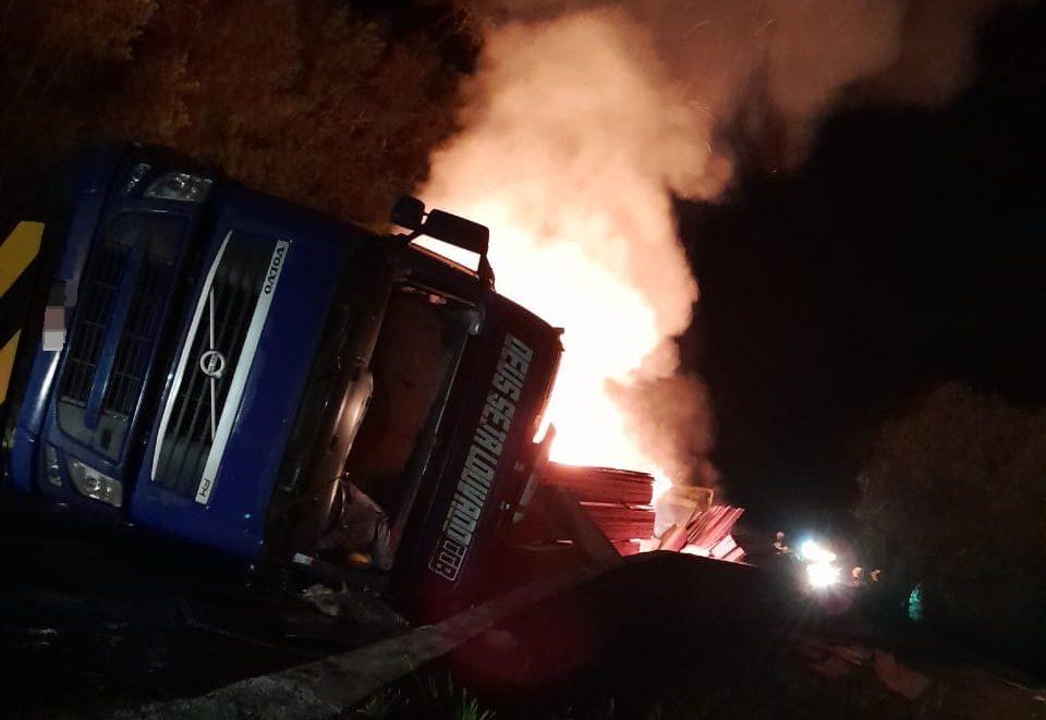 Carreta carregada de madeira tomba e pega fogo na BR-116 em Santa Cecília